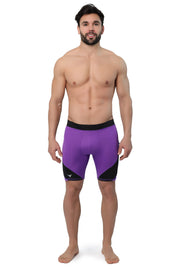 Men's purple compression shorts with black detailing shown on shirtless model, full front view.