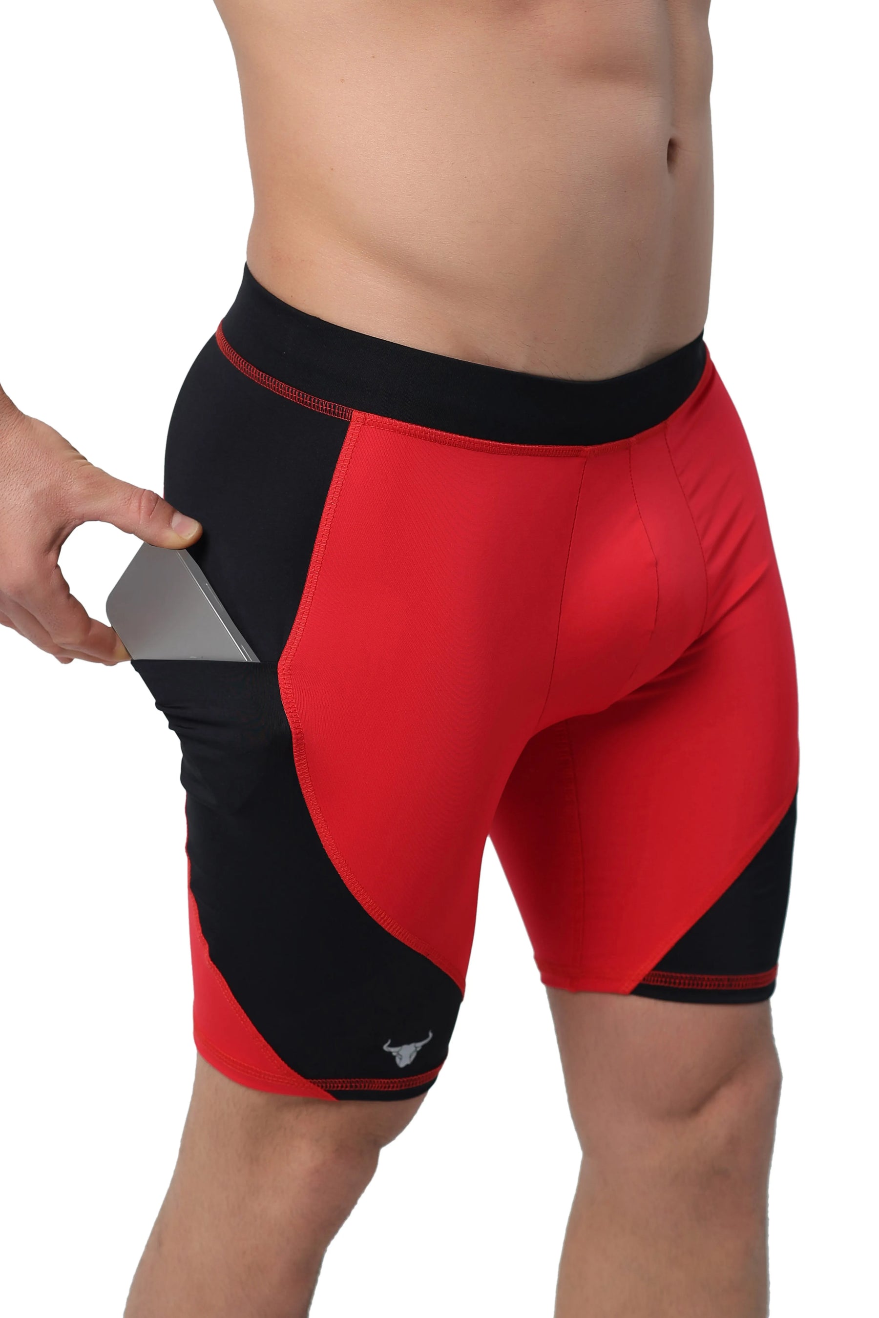 Red compression shorts for men with phone pocket on black side panel.