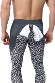 Men's black and grey leggings with abstract print and drawstring waistband.