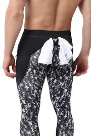 Skull leggings for men featuring black and white skull print with rear shirt loop for convenience.