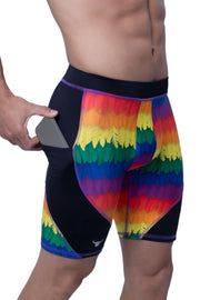 Men's short leggings with rainbow feather-like pattern and black side pocket holding a smartphone.