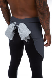 Men's leggings with shirt loop featuring a built-in back strap to securely hold a towel or shirt, shown in a black and gray performance design ideal for training sessions.