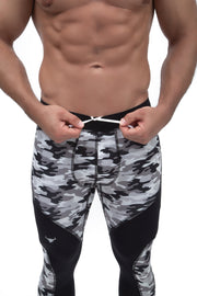 man adjusting black and gray camo meggings