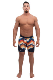 male model wearing multi-color compression shorts with multicolor arrow printed design