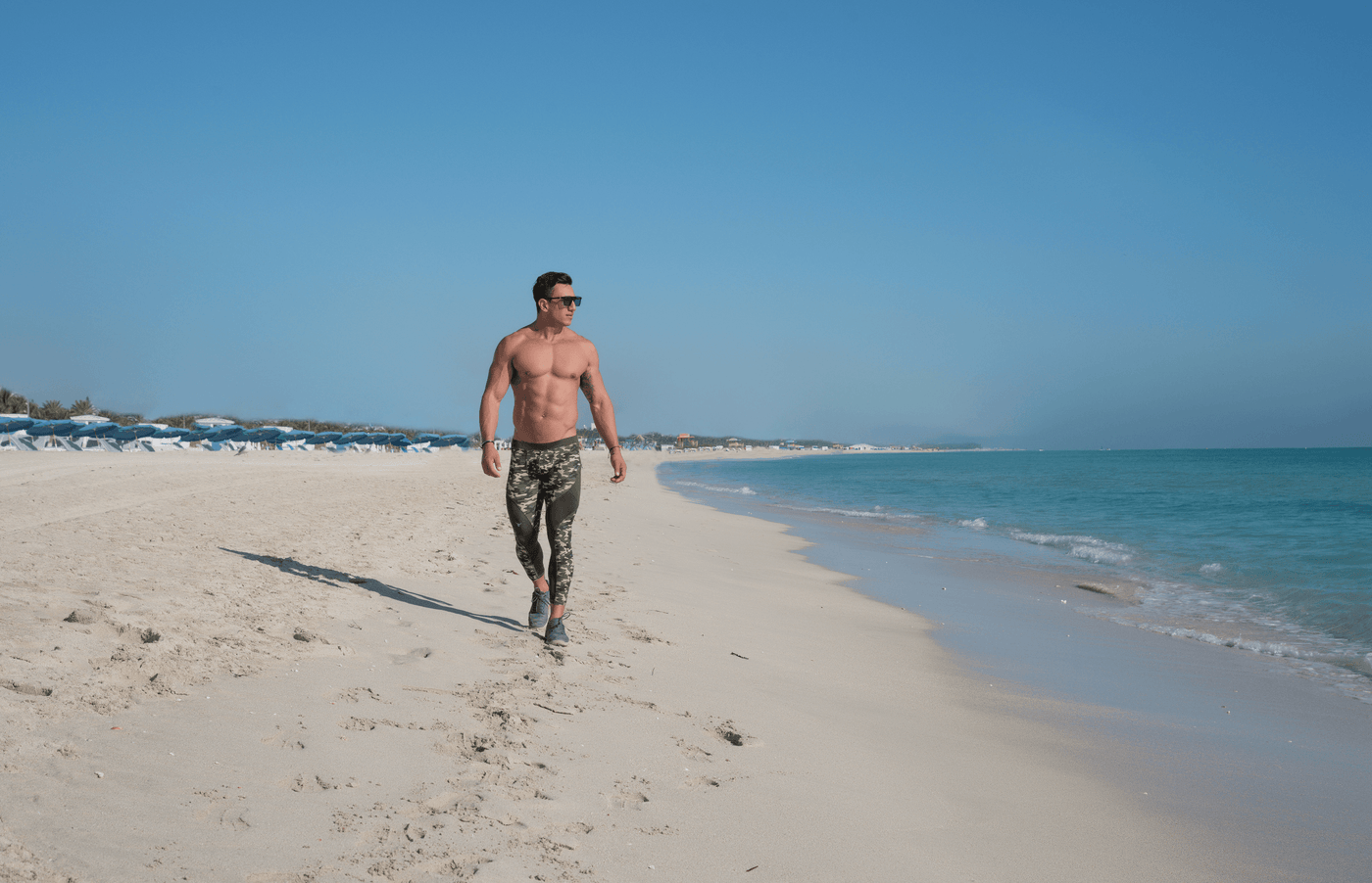 Man wearing Matador Meggings walking on  the beach