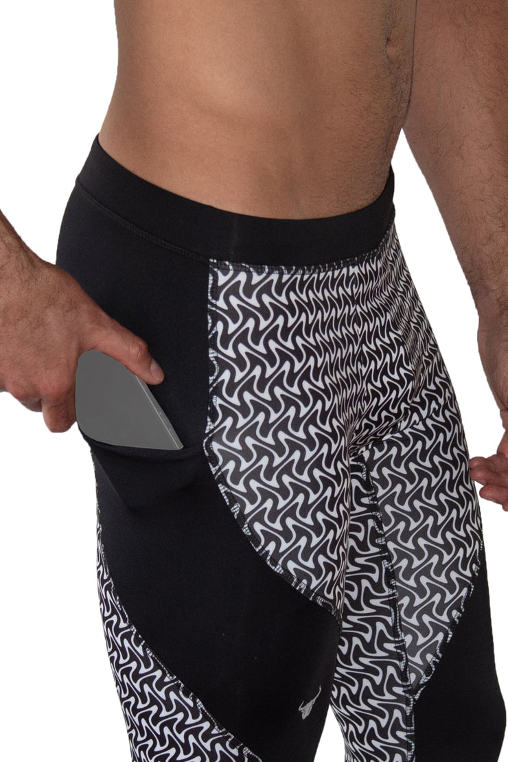 Side view of black and white zigzag compression tights with phone pockets