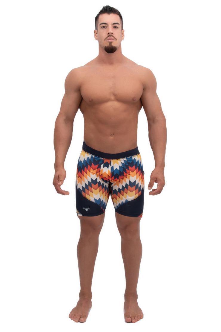 male model wearing multi-color compression shorts with multicolor arrow printed design