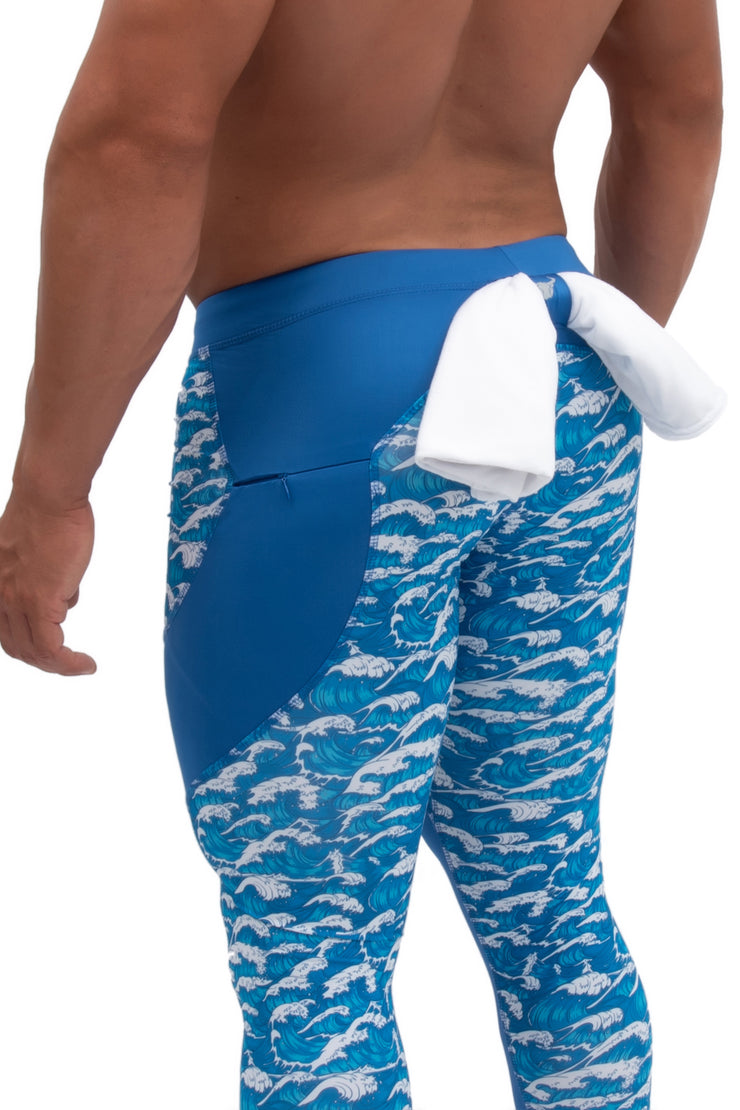 Back of blue tsunami compression tights for men with printed waves design